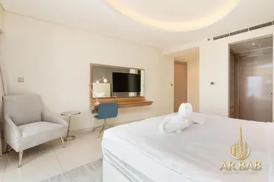 a room with a bed with a stuffed animal on it at Damac Paramount - Luxurious 2BR - Stunning Dubai Canal View - High Level in Dubai