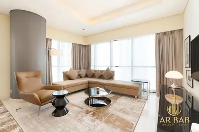 a living room with a couch and a table at Damac Paramount - Luxurious 2BR - Stunning Dubai Canal View - High Level in Dubai