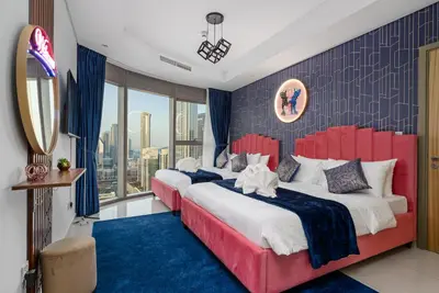 a bedroom with two beds and a large window at Super High Infinity Pool & Stunning Burj Khalifa View, 3-Bedroom Apartment at Paramount Hotel Midtown in Dubai