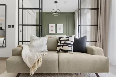 a living room with a couch with pillows on it at Silkhaus Chic 1BDR in Exclusive Neighbourhood in Dubai