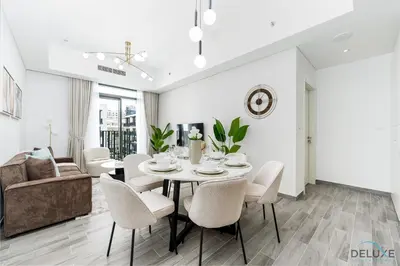 a dining room with a table and chairs at Lovely 2BR at Belgravia Square, JVC by Deluxe Holiday Homes in Dubai