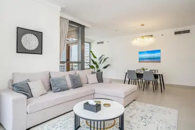a living room with a white couch and a table at Superior New Luxury Living 2BR Apt Dubai Creek Harbour in Dubai