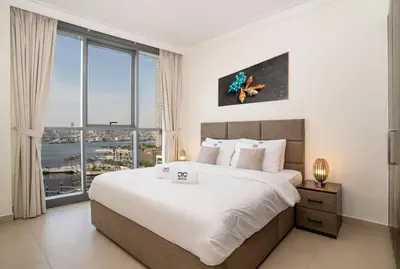 a bedroom with a large bed with a large window at Superior New Luxury Living 2BR Apt Dubai Creek Harbour in Dubai