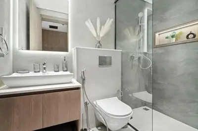 a bathroom with a shower and a toilet and a sink at Modern Studio in residence with pool gym and paddl in Dubai