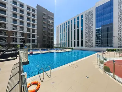 a swimming pool in the middle of a building at Modern Studio in residence with pool gym and paddl in Dubai