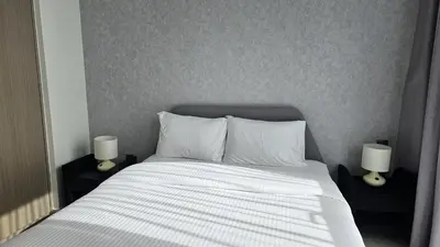 a bedroom with a bed with two lamps on tables at MH- Act Tower - Downtown 1BHK-REF4606 in Dubai