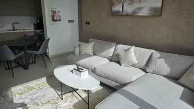 a living room with a couch and a table at MH- Act Tower - Downtown 1BHK-REF4606 in Dubai