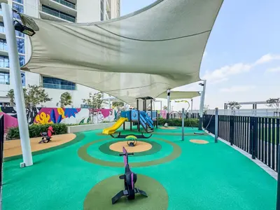 a playground with a slide and a swing at High-Floor 2BR in Aykon City Spacious, Good View in Dubai