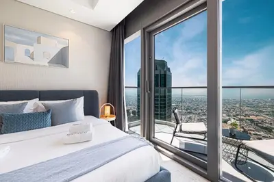a bedroom with a bed and a large window at SmartStay at Paramount Tower - Sea and Downtown Views - Infinity Pool - Modern Luxury Residences in Dubai