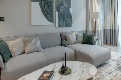 a living room with a couch and a table at Clever Guest 018 JL Marina gate in Dubai