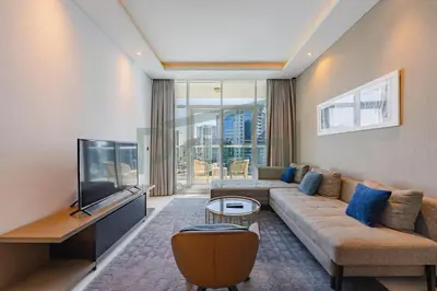 a living room with a couch and a flat screen tv at Prival - Prive in Dubai