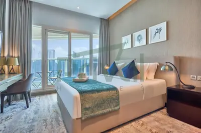 a bedroom with a bed and a desk and a window at Prival - Prive in Dubai