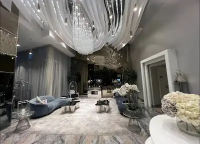 a large living room with couches and a chandelier at Apartment Dubai Marina, Damac Heights 804 in Dubai