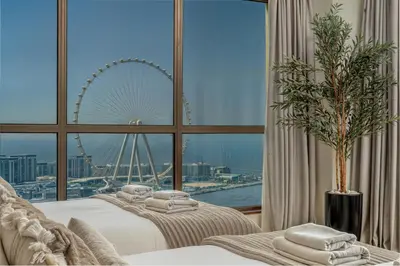 a hotel room with two beds and a large window at Luxury Dubai Eye View Living - Beach access I Marina Walk in Dubai