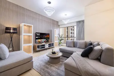 a living room with two couches and a flat screen tv at Luxury Dubai Eye View Living - Beach access I Marina Walk in Dubai
