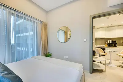 a bedroom with a bed and a large window at Brand new cozy 1 bedroom in Business Bay in Dubai