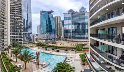 an aerial view of a pool in a city with tall buildings at Brand new cozy 1 bedroom in Business Bay in Dubai