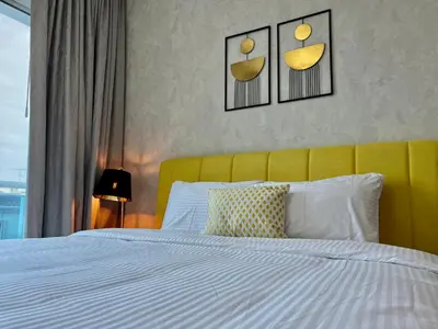 a bedroom with a white bed with a yellow headboard at Cosmos Living Stunning Apt in Lago Vista IMPZ in Dubai