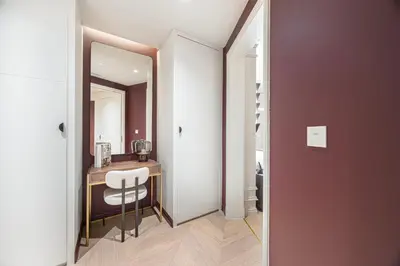 a hallway with a table and a chair in a room at The Address Fountain Views - Residence 2 Bedroom with Burj Khalifa view and access to Dubai mall in Dubai