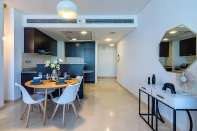 a kitchen and dining room with a table and chairs at DIFC 1BR at SkyGardens Tower in Dubai