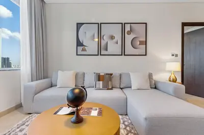 a living room with a couch and a table at DIFC 1BR at SkyGardens Tower in Dubai