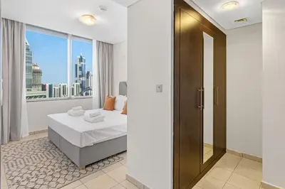 a hotel room with a bed and a window at DIFC 1BR at SkyGardens Tower in Dubai