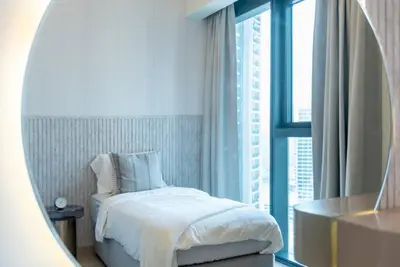 a bedroom with a bed and a large window at FIRST CLASS 2BR In the HEART of Downtown Dubai in Dubai