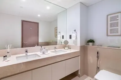 a bathroom with two sinks and a large mirror at FIRST CLASS 2BR In the HEART of Downtown Dubai in Dubai
