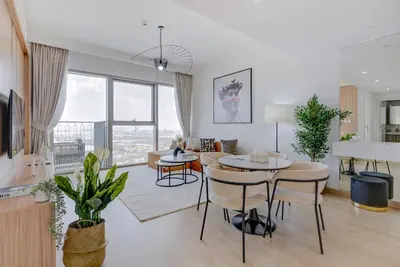 a living room with a table and chairs at Trophy Live in the Sky Luxury Moon Collection Suites with DIFC Views 45Th Floor in Dubai
