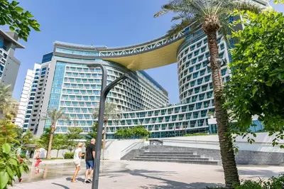 a group of people standing in front of a large building at Keysplease Studio W/Beach Access near Mall, Palm Jumeirah in Dubai