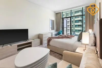 a bedroom with a bed and a tv and a couch at Keysplease Studio W/Beach Access near Mall, Palm Jumeirah in Dubai