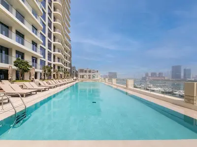 a large swimming pool on the roof of a building at Sea and Palm View from 1BD apt in Beachfront in Dubai