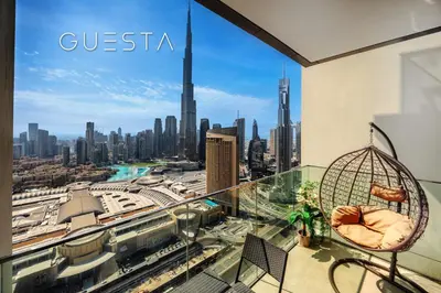 a room with a balcony with a view of a city at Downtown Views I - Burj Khalifa View, Downtown Dubai in Dubai