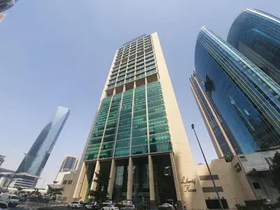 a tall building with cars parked in front of it at Silkhaus Modern Studio in The Heart of DIFC in Dubai