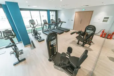 an overhead view of a gym with cardio equipment at Wonderful Studio with Balcony & City Views in Dubai