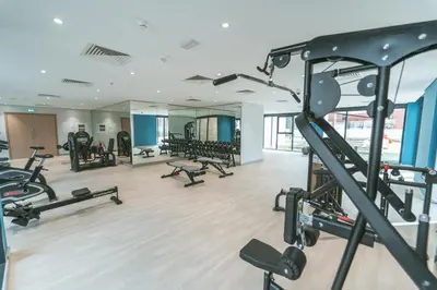 a gym with treadmills and machines in a building at Wonderful Studio with Balcony & City Views in Dubai