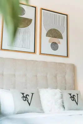 two framed pictures on a wall above a couch at Wonderful Studio with Balcony & City Views in Dubai