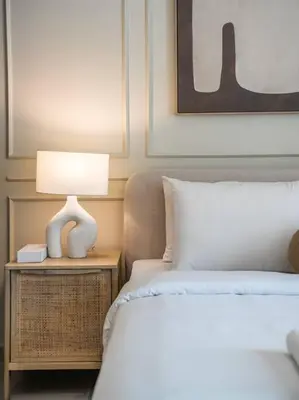 a bedroom with two beds and a lamp on a night stand at Sunset Creek Oasis: 1BR Gem Luxury Beach Apartment in Dubai
