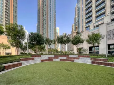 a park in the middle of a city with tall buildings at Burj Khalifa Views Stylish 2BR Near Dubai Mall and Metro in Dubai