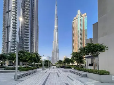 a street in a city with tall buildings at Burj Khalifa Views Stylish 2BR Near Dubai Mall and Metro in Dubai