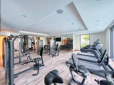 a gym with several treadmills and cardio machines at Burj Khalifa Views Stylish 2BR Near Dubai Mall and Metro in Dubai