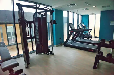 a gym with two tread machines in a room at Stylish Studio Retreat in Dubai