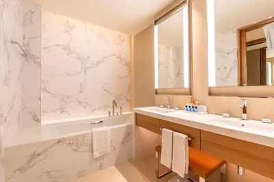 a bathroom with a tub and a sink and a mirror at Address Opera Residences Burj Khalifa View in Dubai