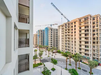 an aerial view of buildings and a crane at Pearl of Creek Beach: 1BR Luxury Beach Apartment in Dubai