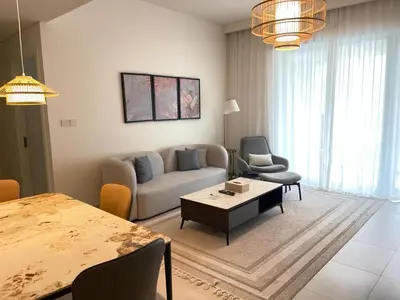 a living room with a couch and chairs and a table at Pearl of Creek Beach: 1BR Luxury Beach Apartment in Dubai