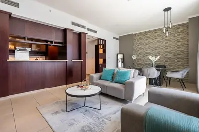 a living room with a couch and a table at Cozy 1 Bedroom apartment I Downtown Dubai I Near Burj Khalifa in Dubai