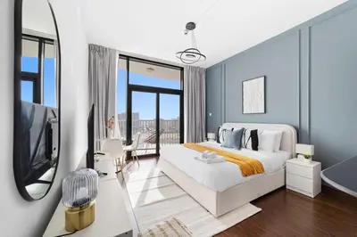 a bedroom with a large bed and a television at Silkhaus Luxury Studio Near Silicon Shopping Mall in Dubai