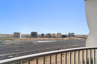 a view of a highway with buildings in the background at Silkhaus Luxury Studio Near Silicon Shopping Mall in Dubai