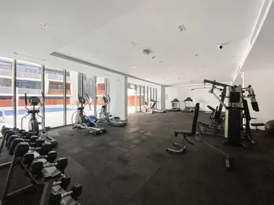 a gym with several exercise bikes and a pool at Silkhaus Modern Studio near Silicon Shopping Mall in Dubai