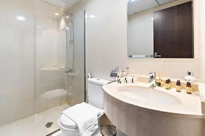 a bathroom with a sink and a toilet and a shower at Modern Luxurious Studio in Dubai Silicon Oasis in Dubai